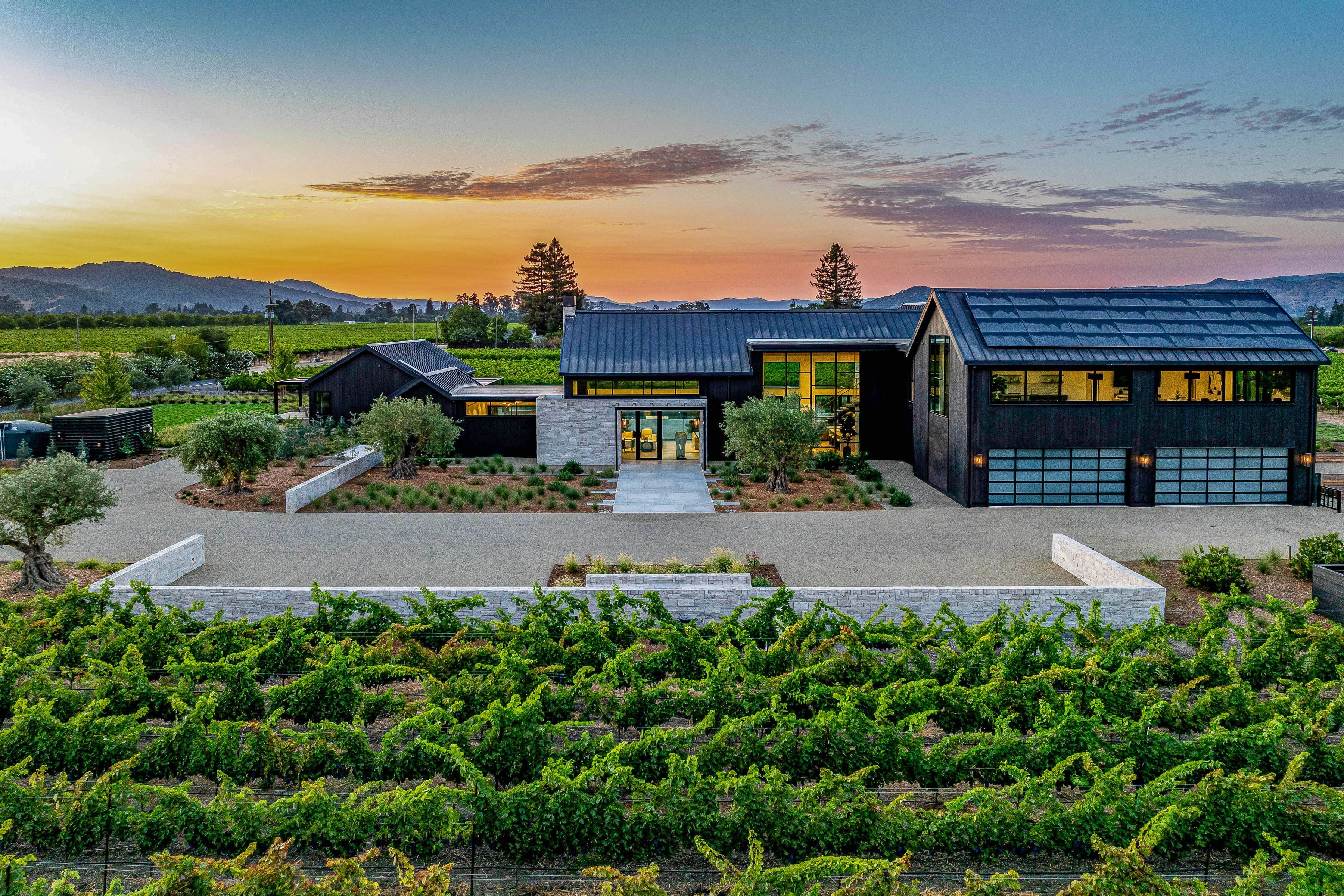 home with mountains in the background and vineyards in the foreground