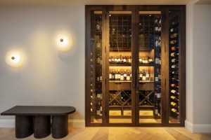 A walk-in wine room with bespoke lighting by Hux London.
