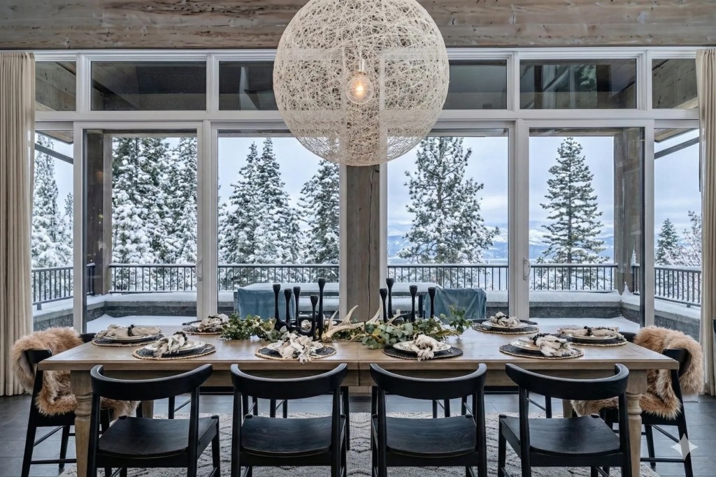 dining room table with snowy views from large windows