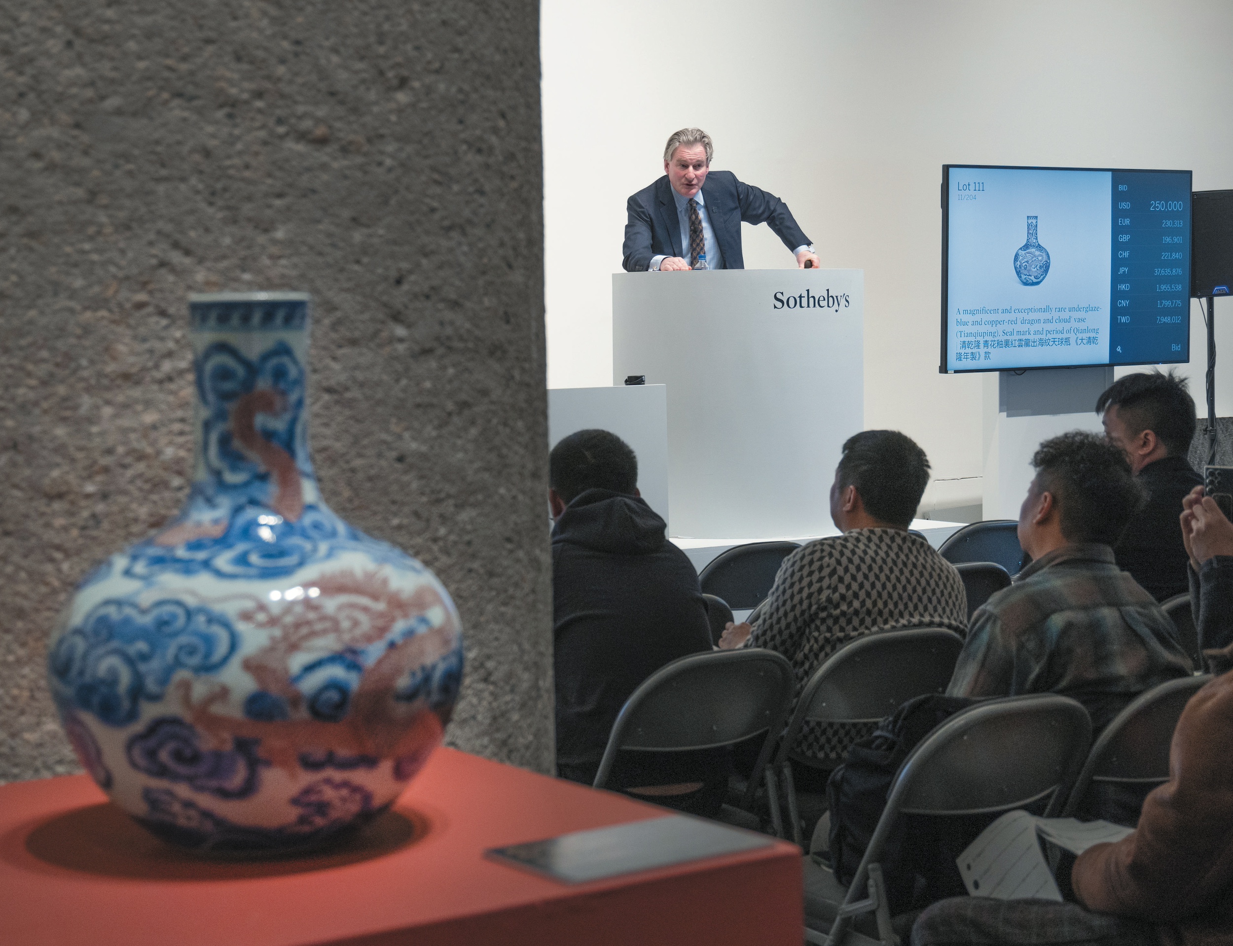 rare Chinese dragon and cloud vase with Sotheby's auction in the background