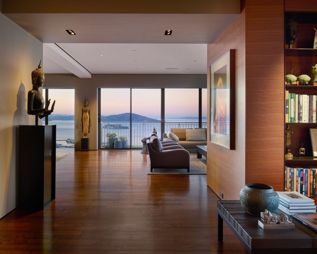 warm wood room with bookshelves, art, and San Francisco views