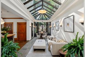 sitting and breakfast room with large skylight surrounded by lush greenery