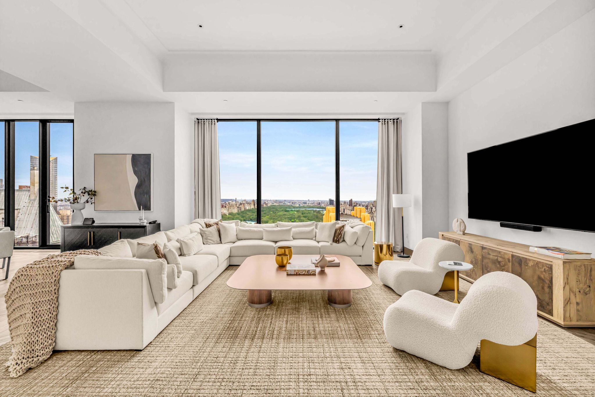 sitting room with white furniture and park views