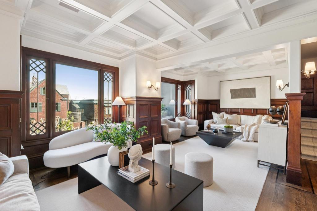 sitting room with white furniture, wood moldings, and San Francisco views