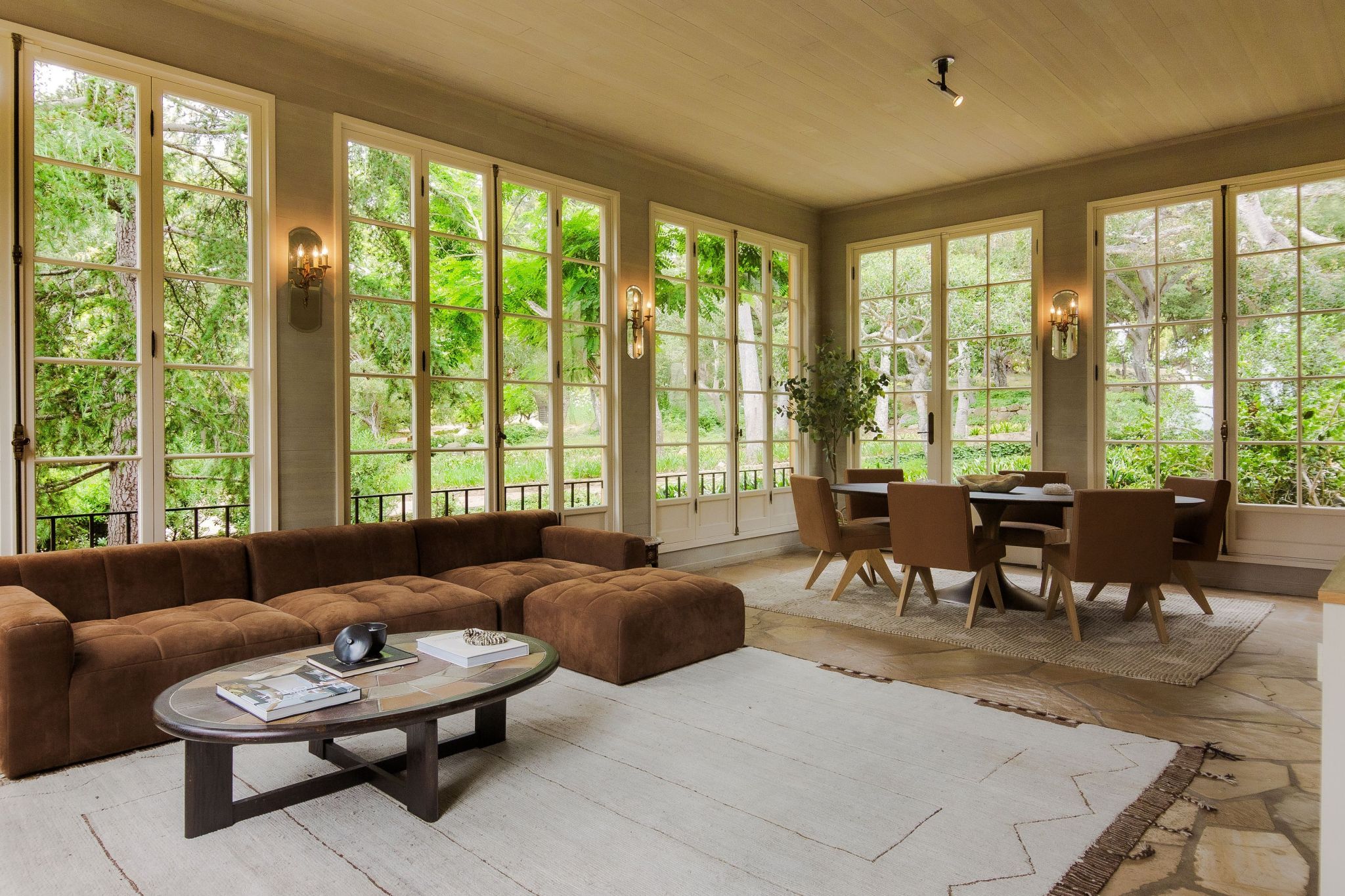 living and dining space with green walls and large windows