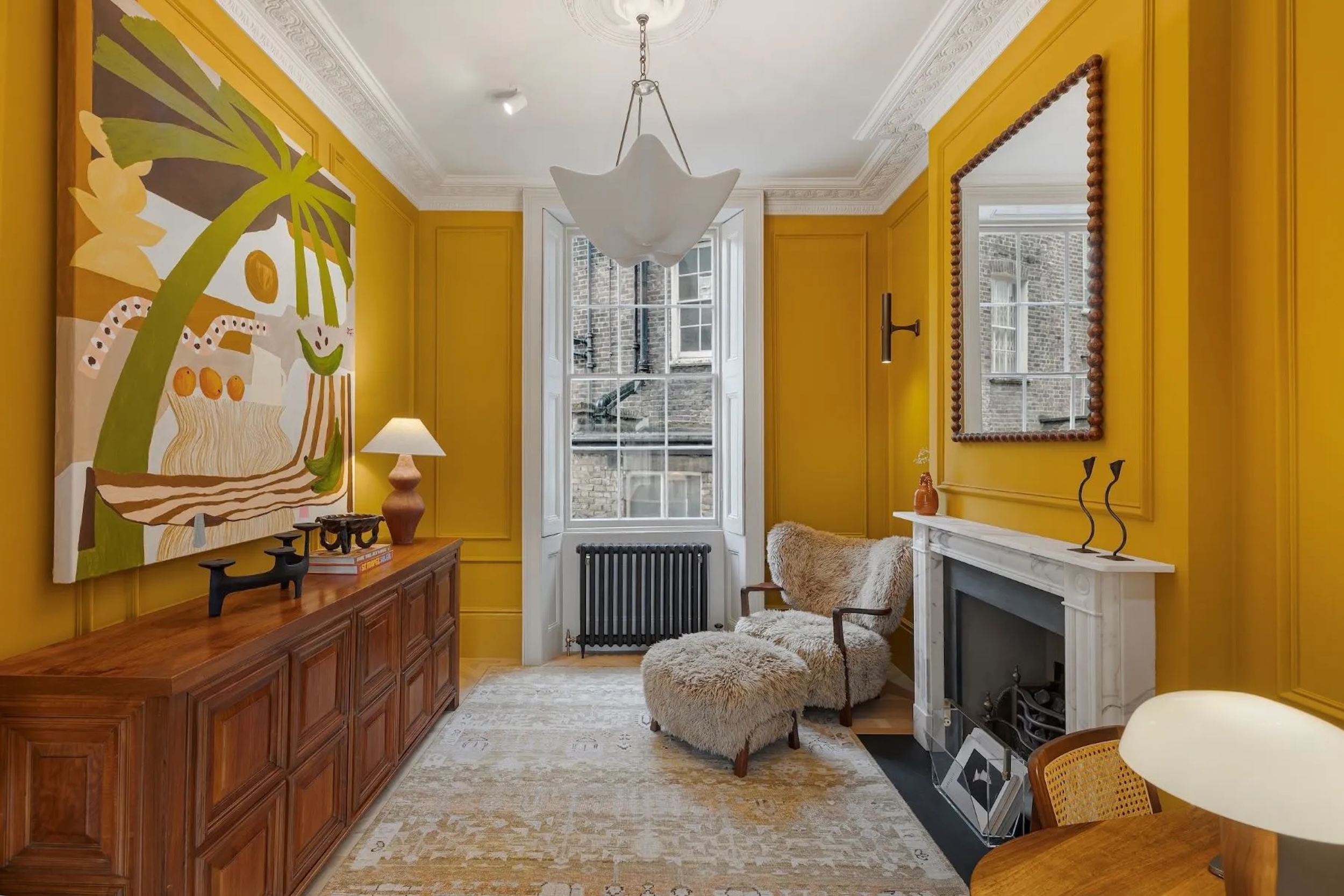 sitting room with yellow walls and a fireplace