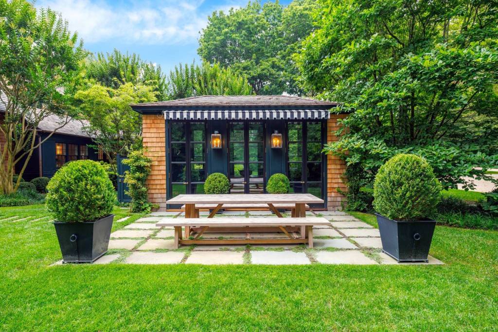 pool house with picnic dining area and mature lanscaping