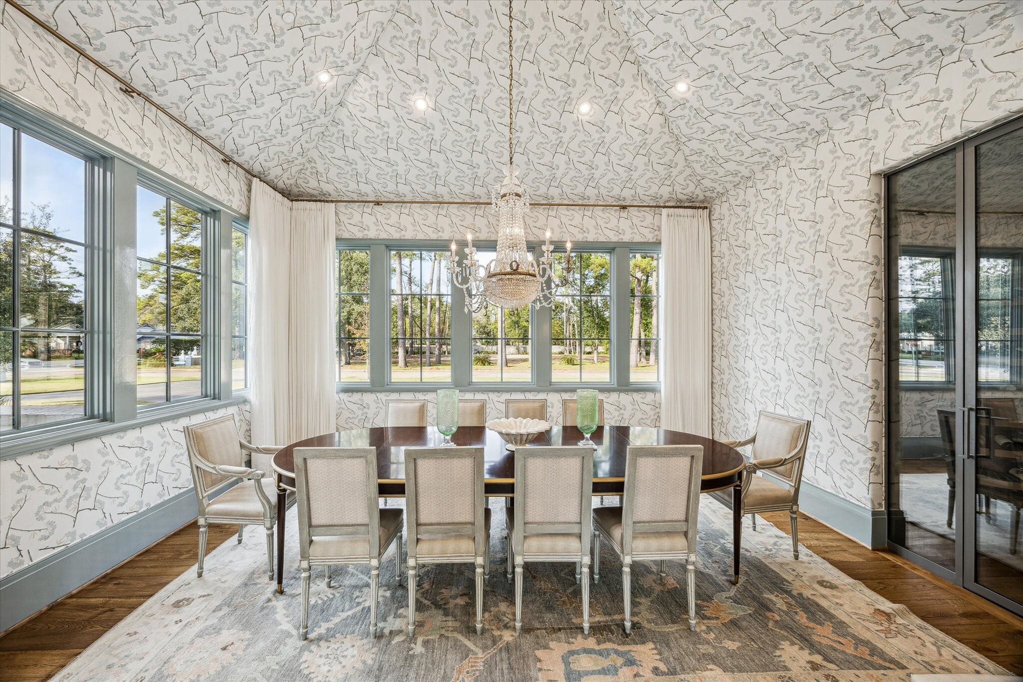 dining room with ornate wall coverings and chandelier