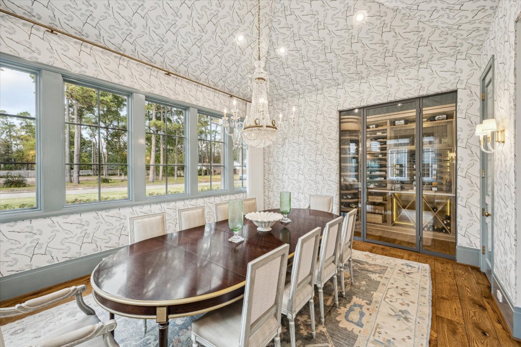 dining room with wine cellar and ornate chandelier