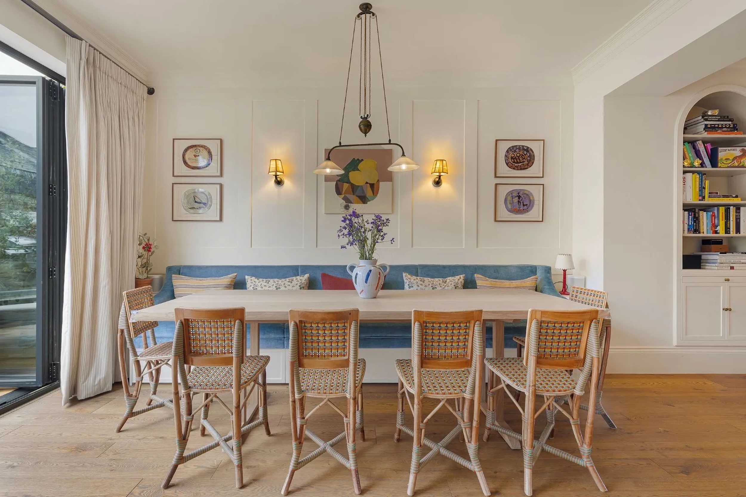 Notting Hill home dining area with bench seating and wall decor