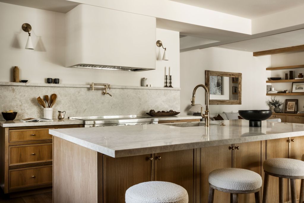 chef's kitchen with counter seating, quartzite countertops, and oak cabinets