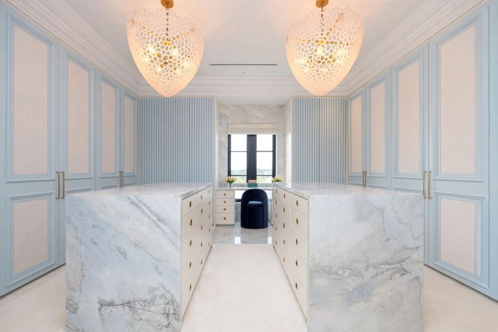 blue and white dressing room with white marble waterfall counters
