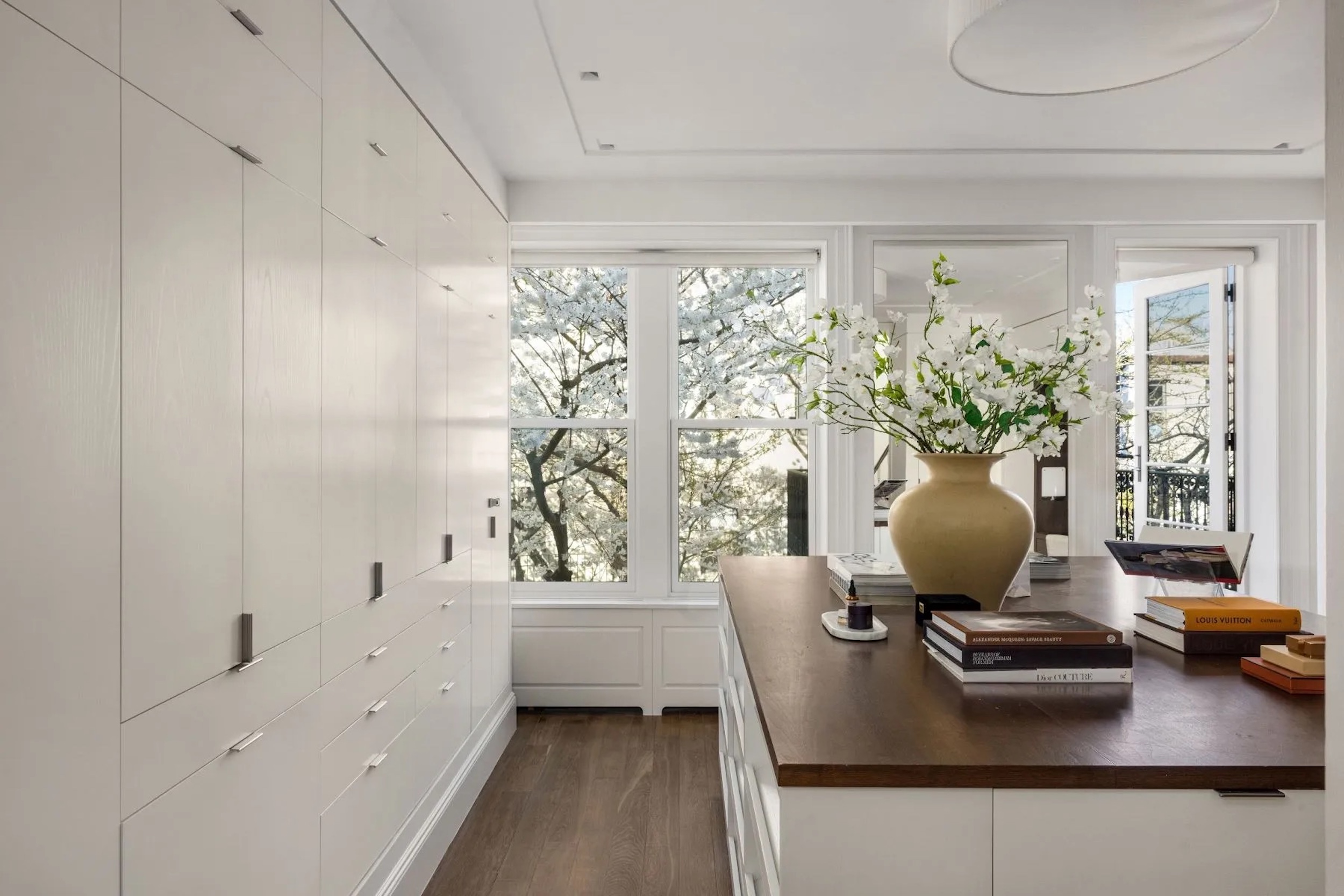 dressing room with white cabinetry and shelving