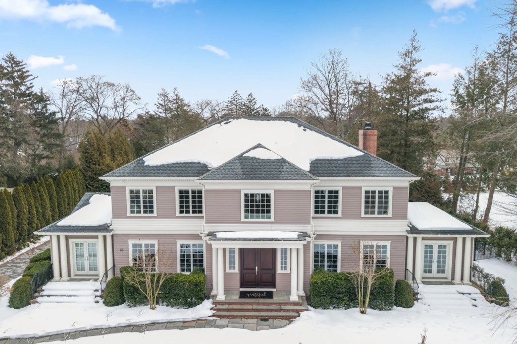 home exterior with lilac siding, covered in snow