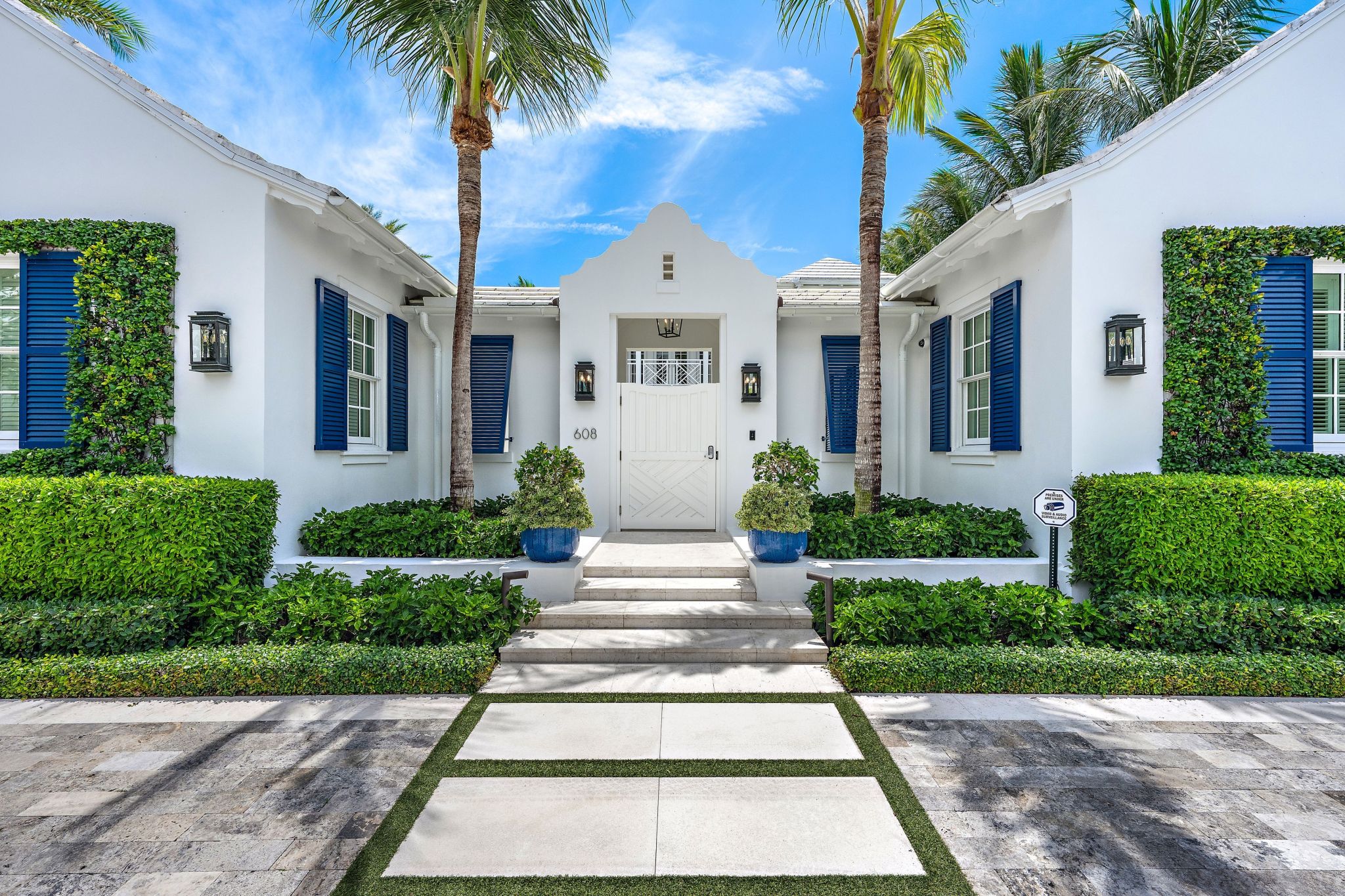 exterior of white home with blue shutters in Palm Beach