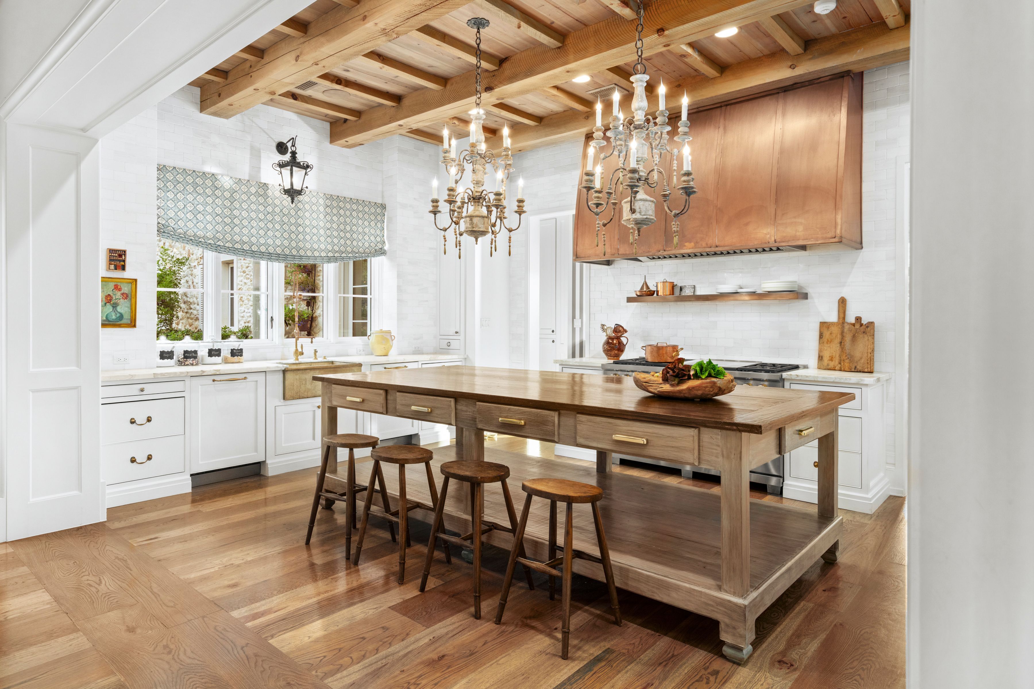 kitchen with copper vent hood and wood kitchen island