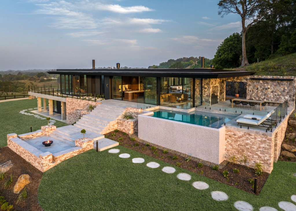 contemporary Byron Bay home with brick, stone, and glass exteriors