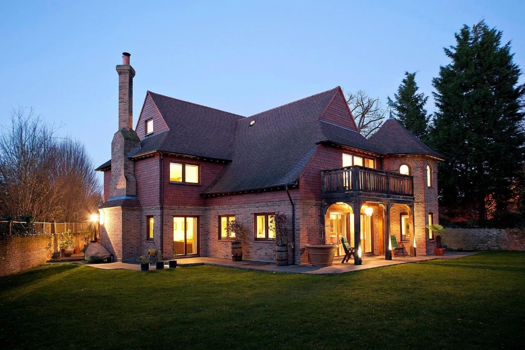 Exterior of brick home with sloped rooflines in the private Coombe Estate