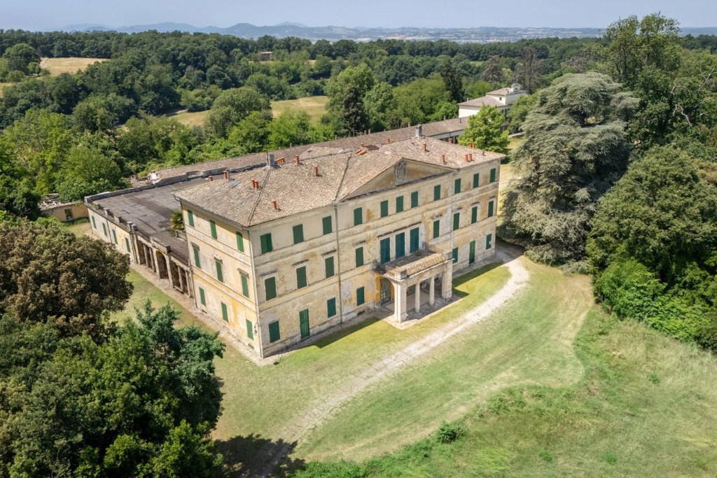 Casino dei Boschi, an18th century Italian stone villa, surrounded by parkland and trees.