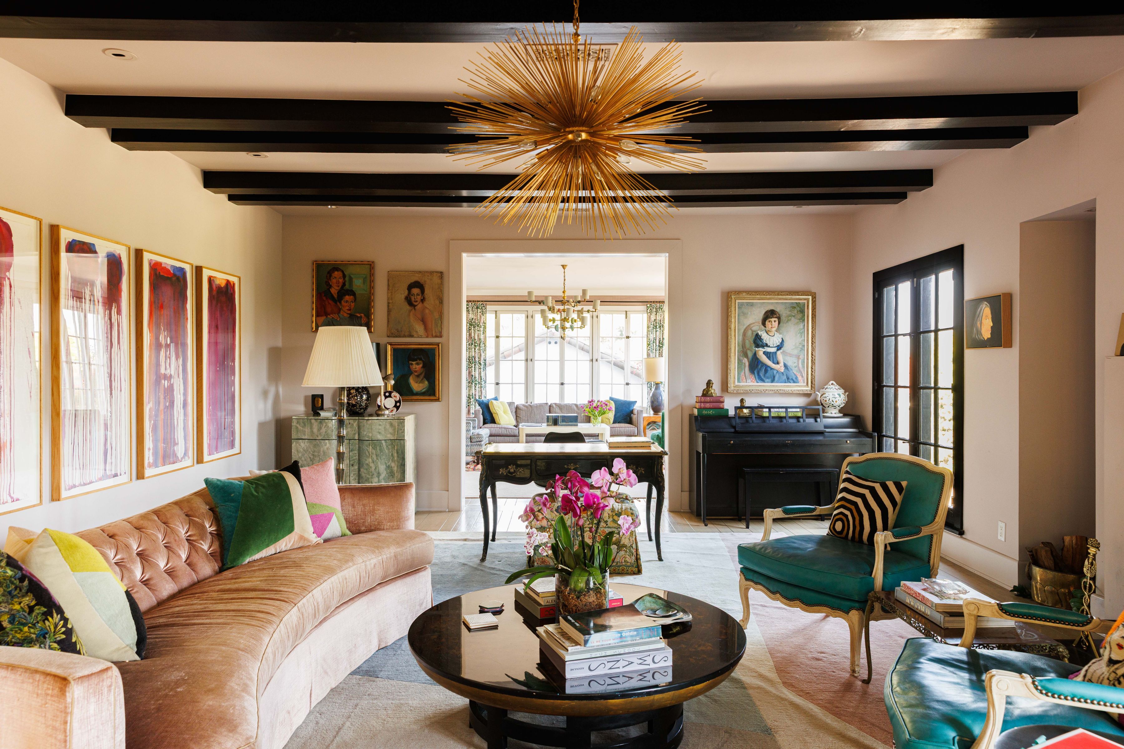 sitting room with colorful furniture and art, featuring starburst chandelier