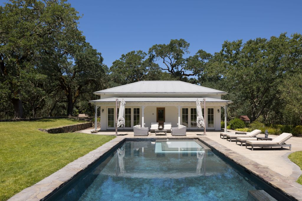 pool terrace and exterior of guest house with French doors in Glen Ellen, California