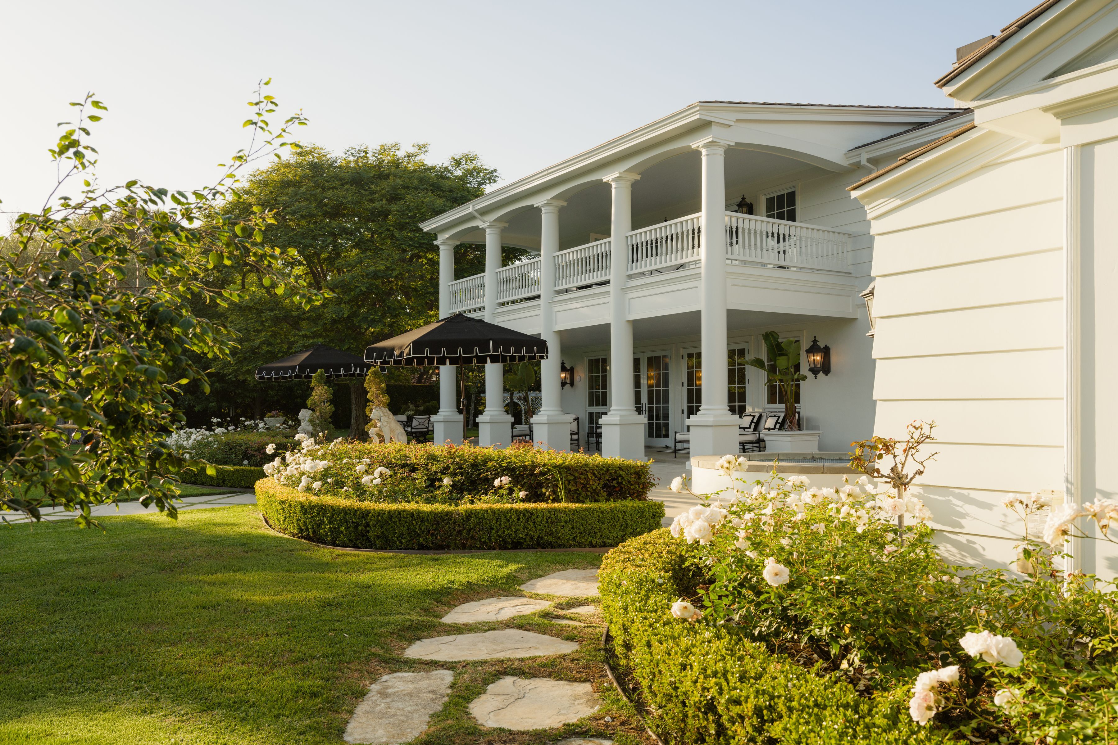 garden terraces and white home exterior with balcony in Santa Barbara's Four Oaks
