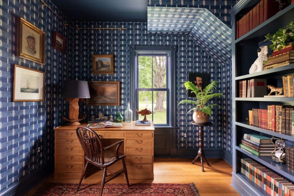 a Hudson Valley home office with floor to ceiling navy blue patterned wallpaper