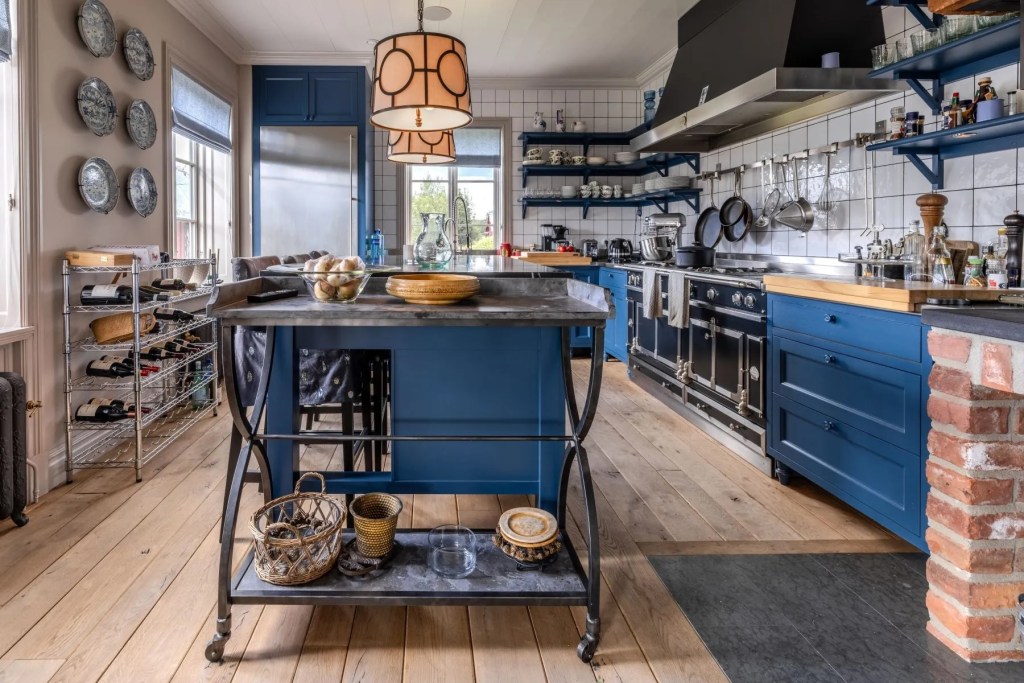 kitchen in Swedish estate with navy blue cabinet accents