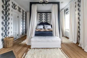bedroom in Swedish estate with white and navy blue accents
