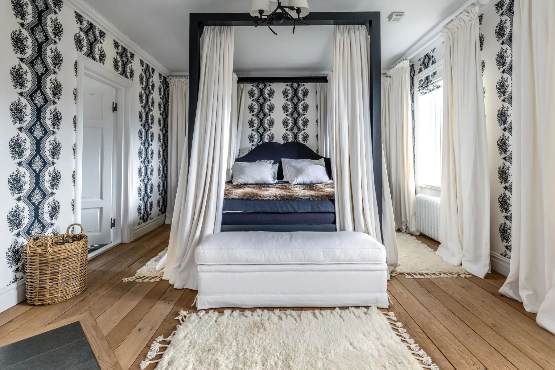 bedroom in Swedish estate with white and navy blue accents