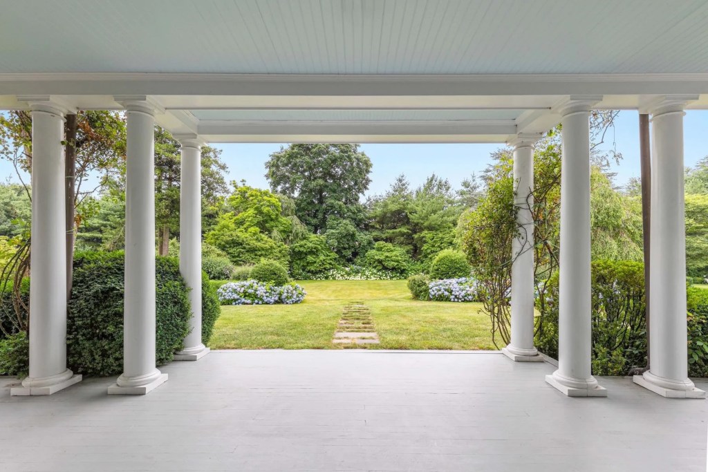 veranda in Purchase, NY home leading out to yard with lush landscaping and flowers