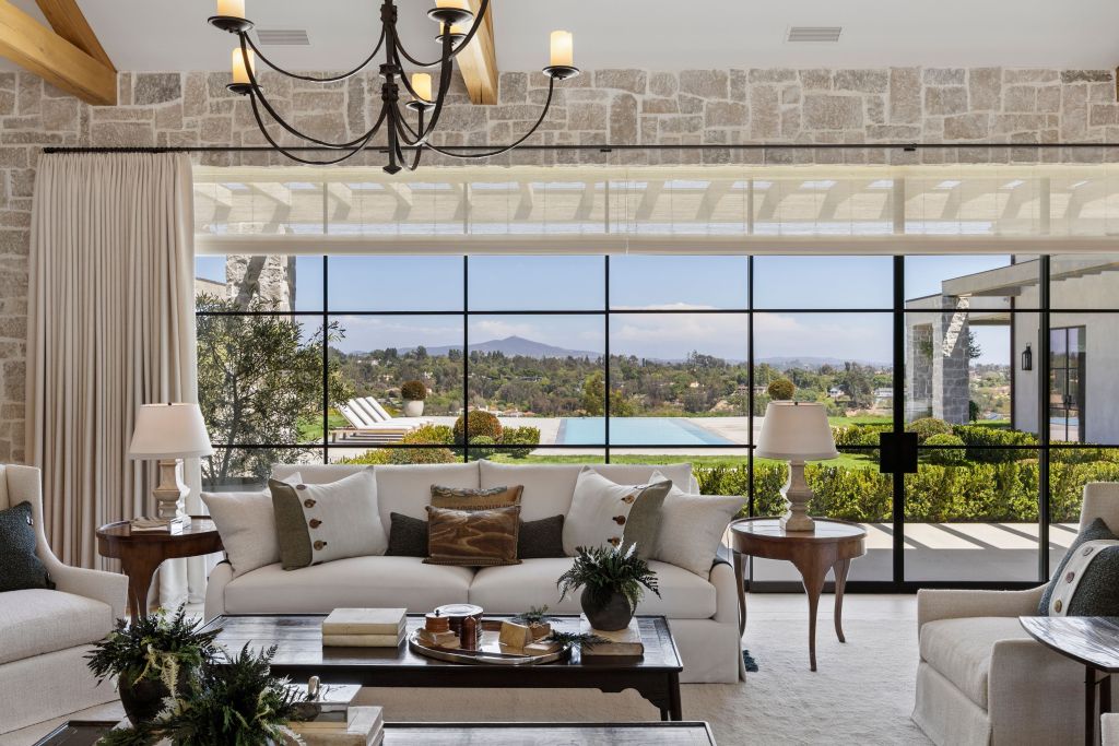 interior sitting room with large windows and glass doors leading to pool deck