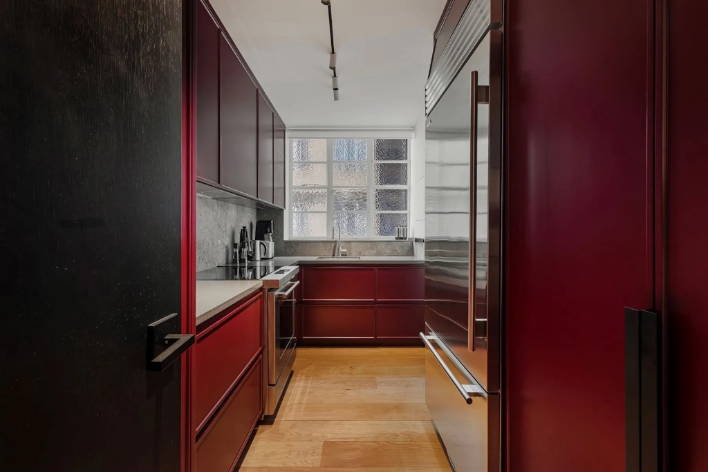 kitchen in London home with burgundy cabinets and walls