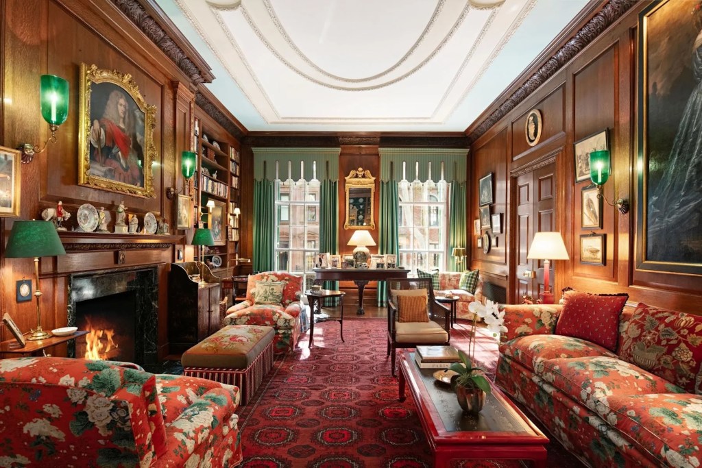 ornate sitting room with burgundy carpet and furniture in New York