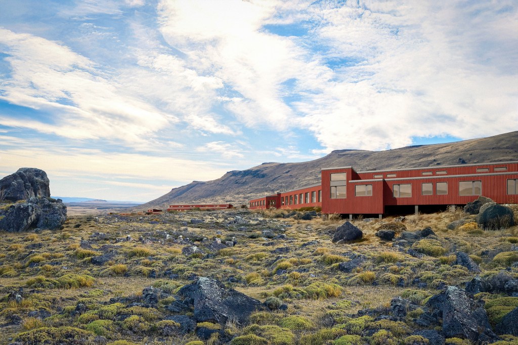 Exterior photo of Explora El Calafate in Patagonia showcasing a long building at the base of a mountain set along rugged, rocky terrain